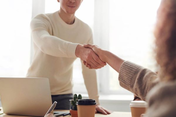 Decorative image of 2 people shaking hands